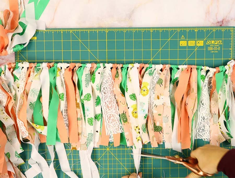 cutting out excess material to tidy up the fabric garland