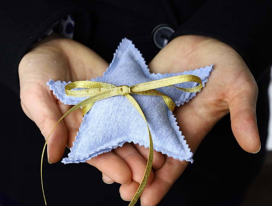 hands holding a diy hand warmer in a star shape