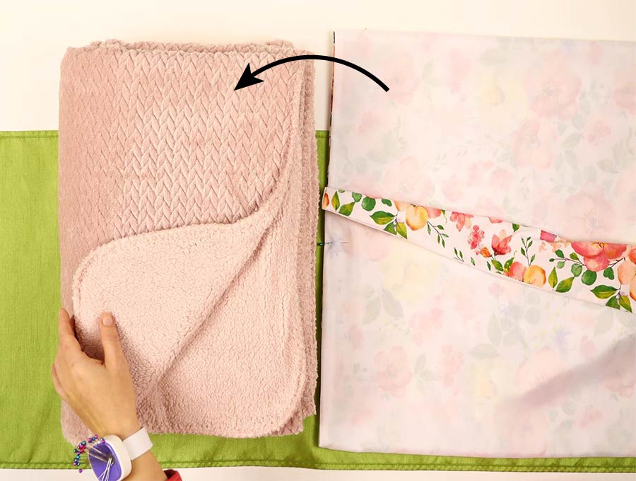 place the pillow cover on top of the blanket to make a quillow