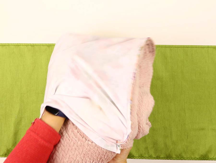 inserting the blanket into the pillow