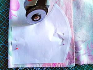 cutting the outer layer of the face mask according to the pattern