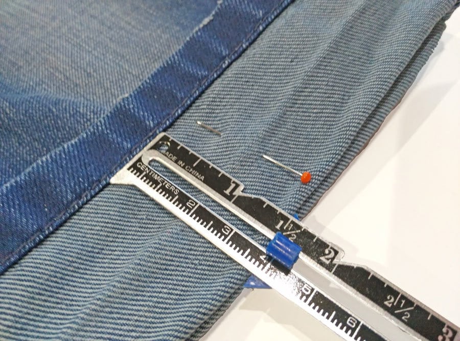 measuring the hem of the jeans