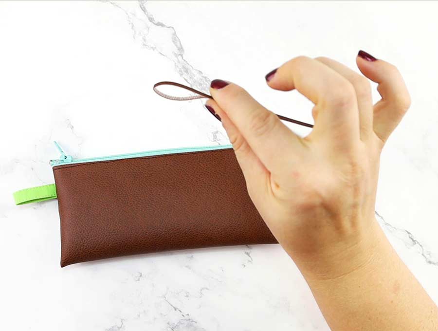 add leather pull tab to the pencil case