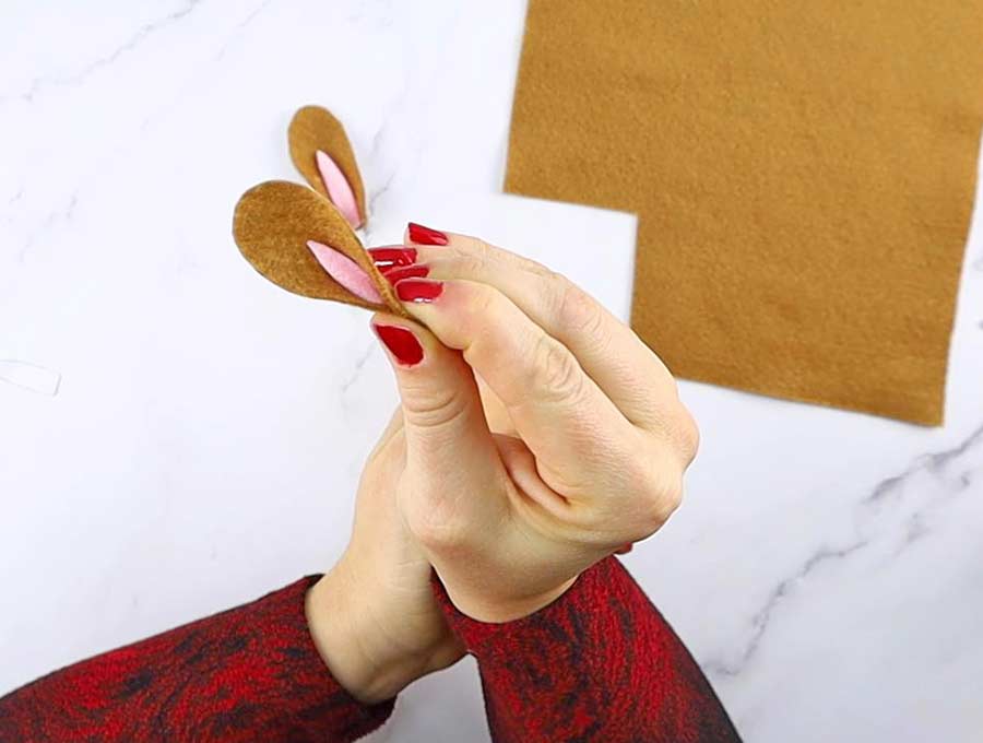 gluing the ears of the pom pom bunny