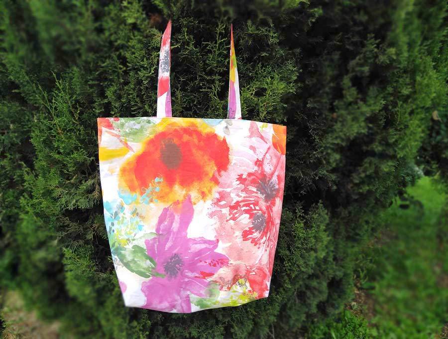 foldable grocery bag hanging on a tree