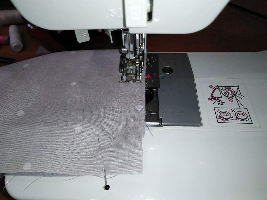 sewing through the layers of the surgical facemask with a sewing machine