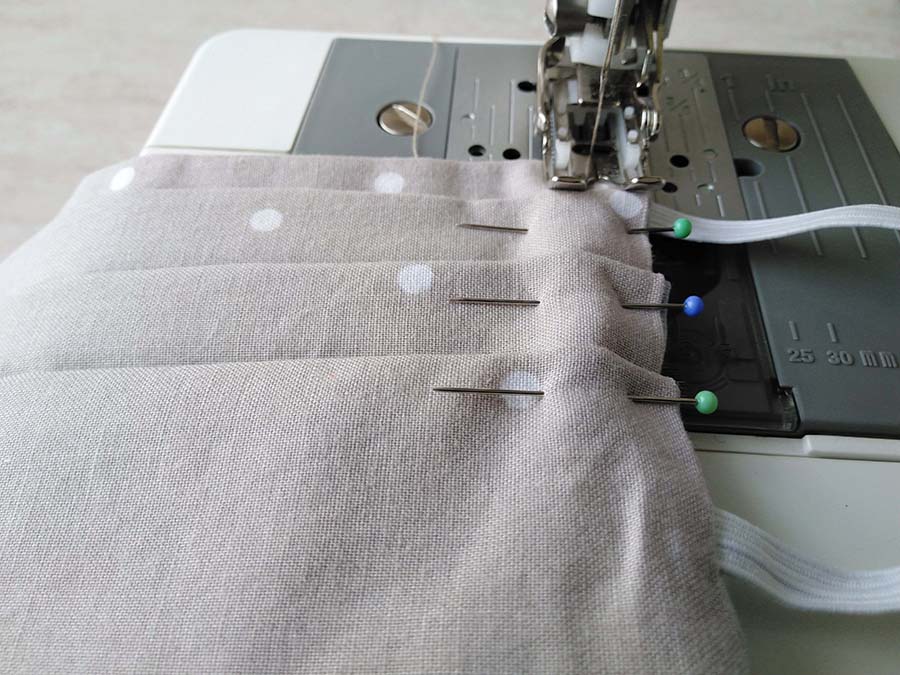 sewing machine foot sewing the pleats of the surgical mask