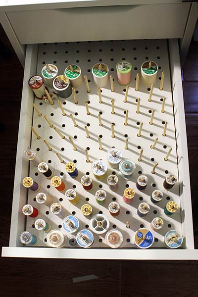 thread storage in a drawer - clever sewing room organization